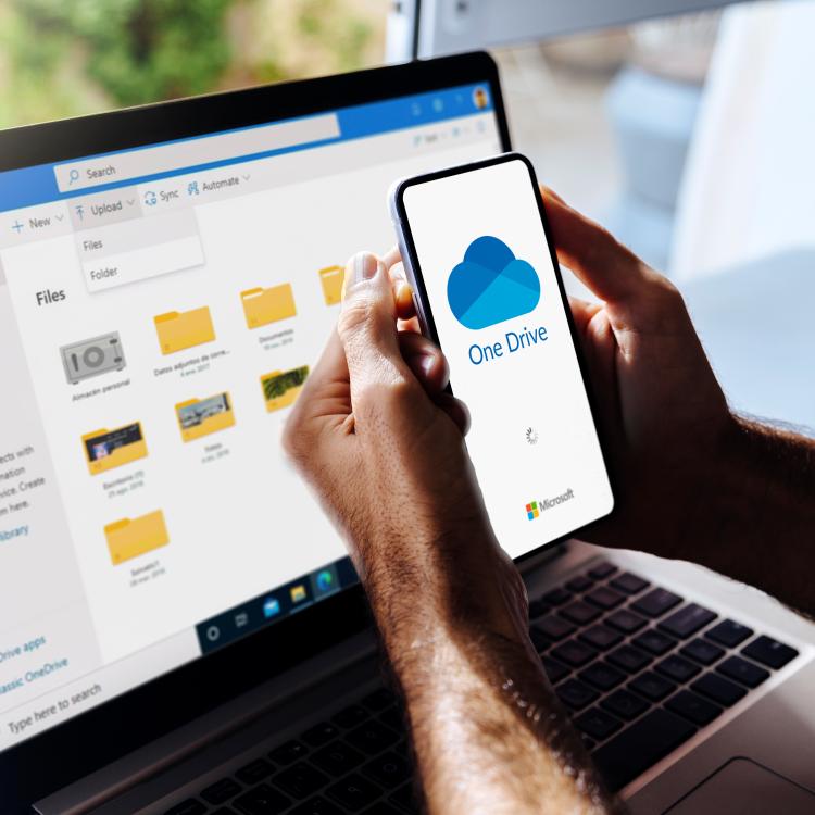  Onedrive on a laptop with a cellphone in the forefront
